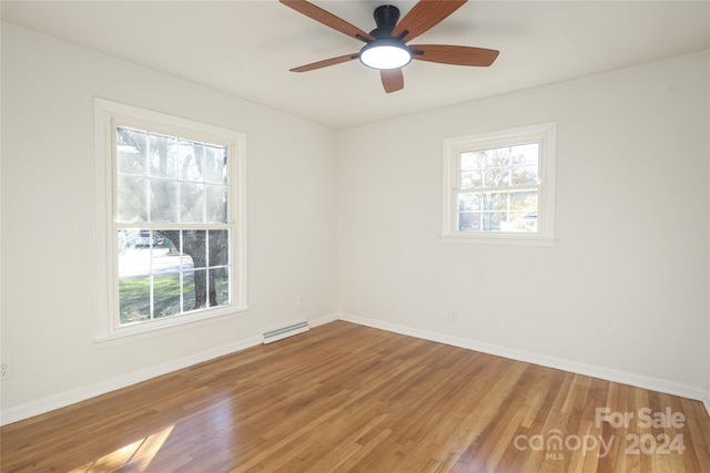 spare room with ceiling fan and hardwood / wood-style flooring