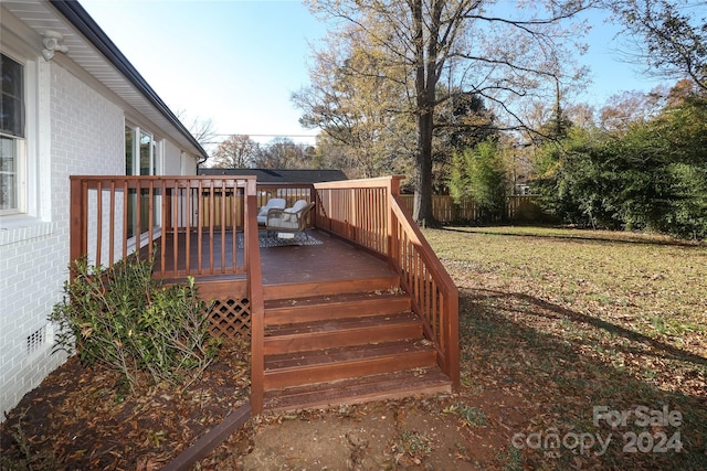 wooden terrace featuring a yard