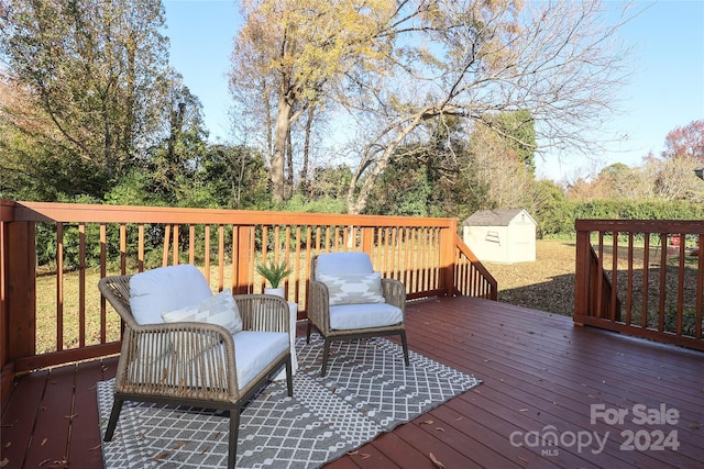 wooden terrace featuring a shed