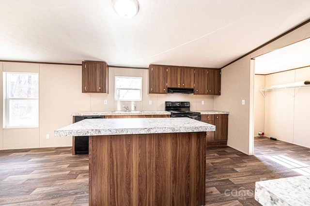 kitchen featuring sink, black appliances, dark hardwood / wood-style floors, and a center island