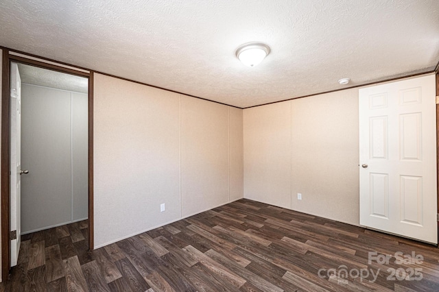 unfurnished bedroom with dark hardwood / wood-style floors and a textured ceiling