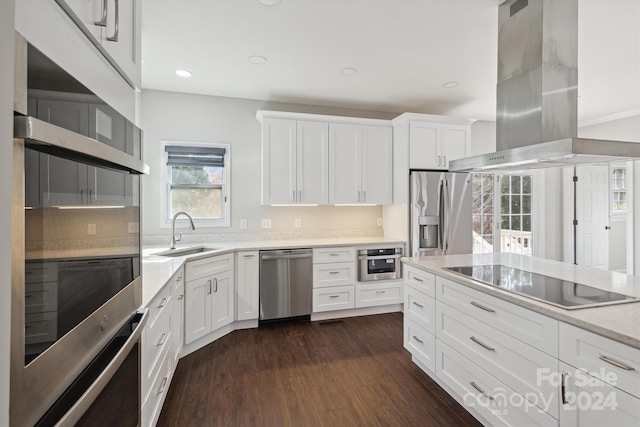 kitchen with white cabinetry, island range hood, sink, and stainless steel appliances