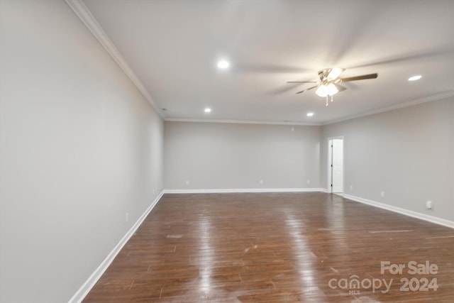 empty room featuring crown molding, dark hardwood / wood-style flooring, and ceiling fan