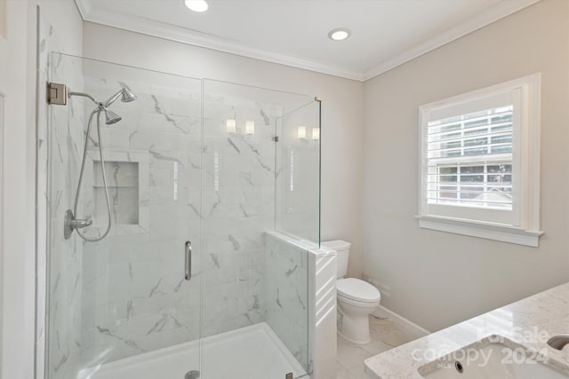 bathroom featuring vanity, toilet, a shower with shower door, and ornamental molding