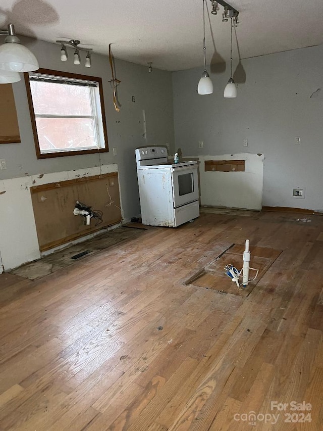 kitchen featuring decorative light fixtures, wood-type flooring, and white electric stove