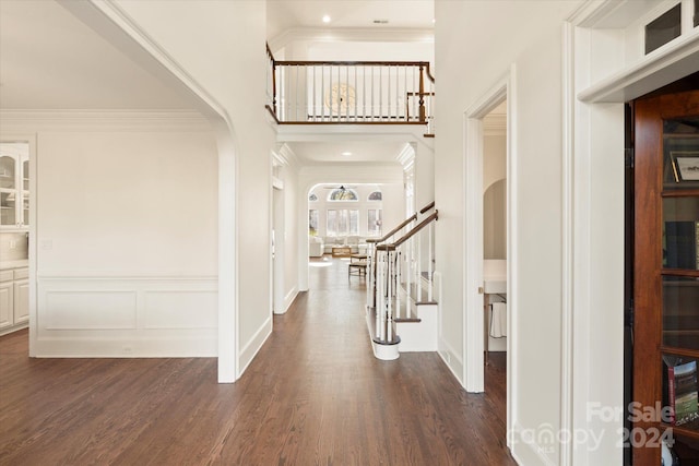 entryway with crown molding, a high ceiling, and dark hardwood / wood-style floors