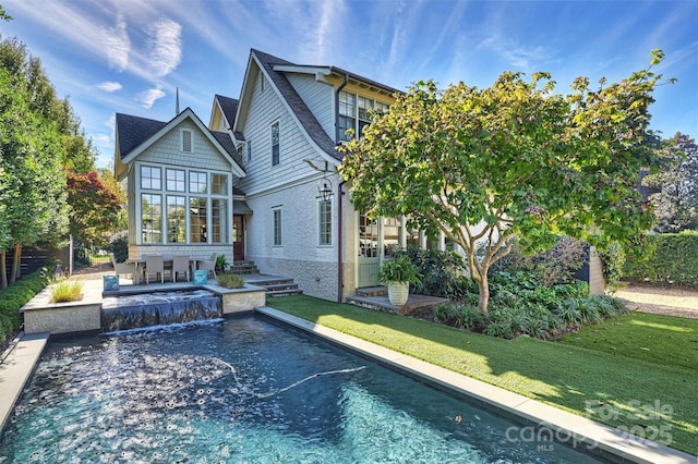 back of house featuring a patio area and a yard