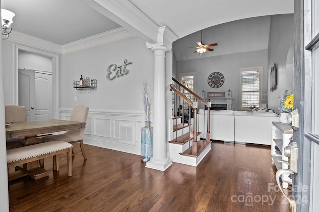 entryway featuring dark hardwood / wood-style flooring, decorative columns, ceiling fan, and ornamental molding