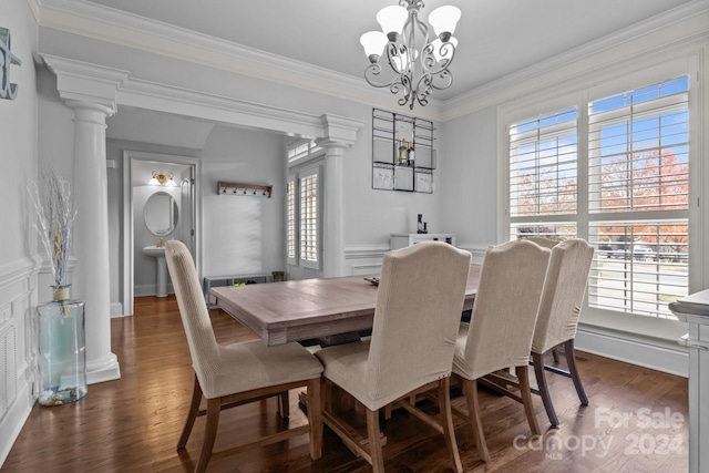 dining space with crown molding, plenty of natural light, dark wood-type flooring, and an inviting chandelier