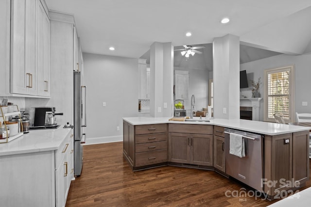 kitchen with white cabinets, dark hardwood / wood-style flooring, stainless steel appliances, and sink