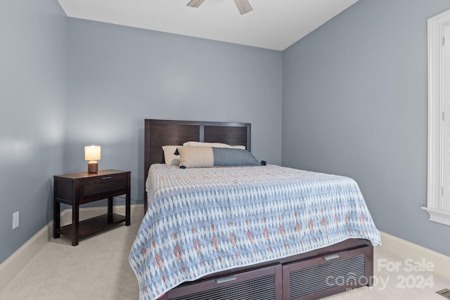 bedroom with light colored carpet and ceiling fan