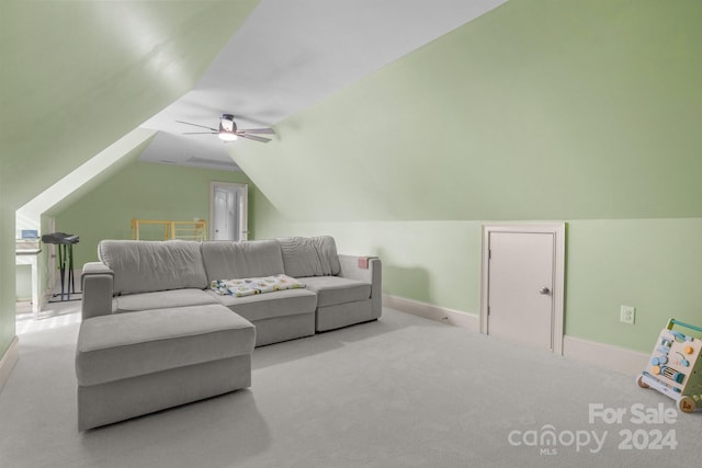 carpeted living room featuring ceiling fan and lofted ceiling