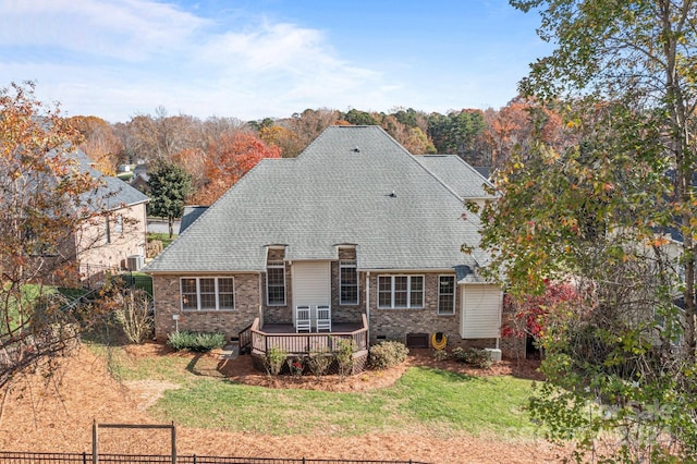 view of front of house featuring a front lawn and a wooden deck