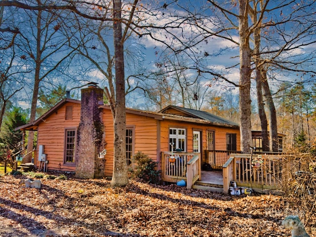 rear view of house featuring a wooden deck