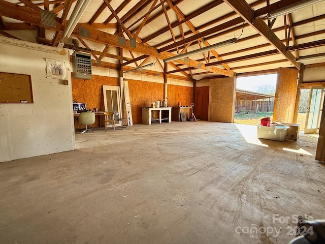 miscellaneous room featuring concrete floors and vaulted ceiling