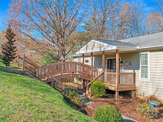 wooden terrace featuring a lawn