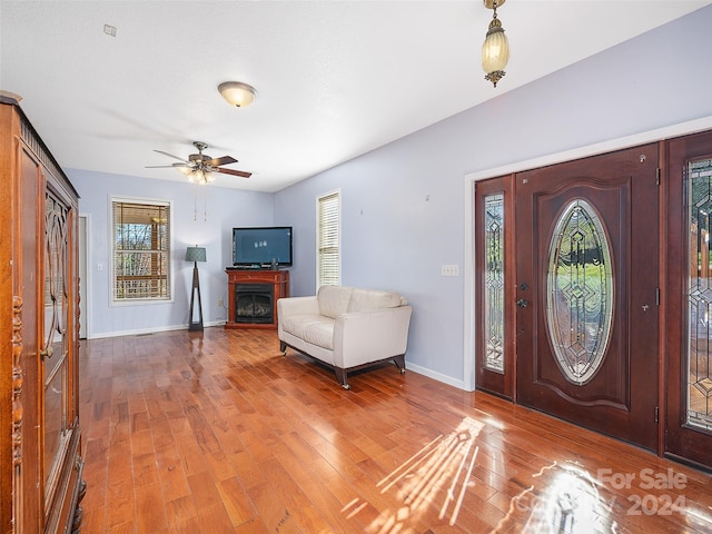 entrance foyer featuring hardwood / wood-style floors, ceiling fan, and a wealth of natural light