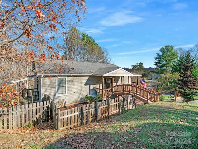 back of property featuring a yard and a deck