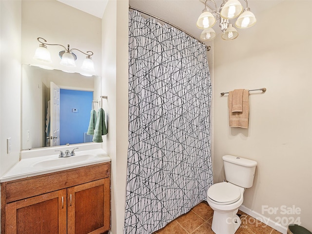 bathroom with tile patterned flooring, vanity, toilet, and curtained shower