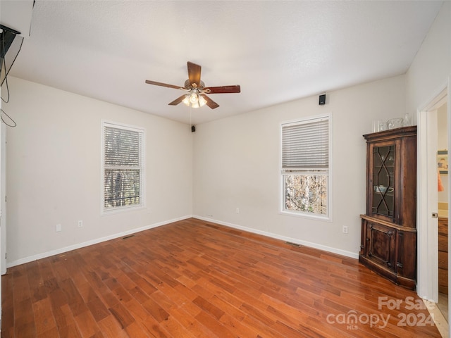 spare room featuring hardwood / wood-style floors and ceiling fan