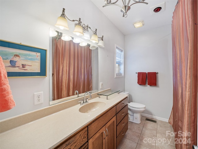 bathroom featuring tile patterned floors, vanity, toilet, and an inviting chandelier