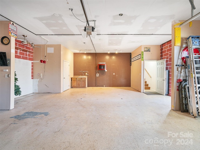 garage featuring a wall mounted AC and a garage door opener