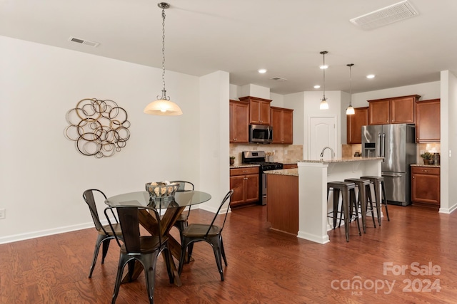 dining area with sink and dark hardwood / wood-style floors