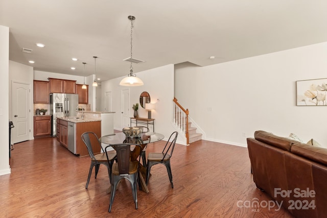 dining area featuring dark hardwood / wood-style floors and sink