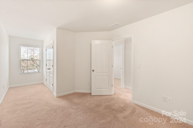 unfurnished bedroom featuring light colored carpet