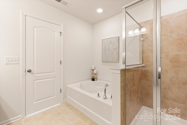 bathroom featuring tile patterned floors and separate shower and tub