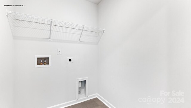 clothes washing area with electric dryer hookup, hookup for a washing machine, and hardwood / wood-style floors