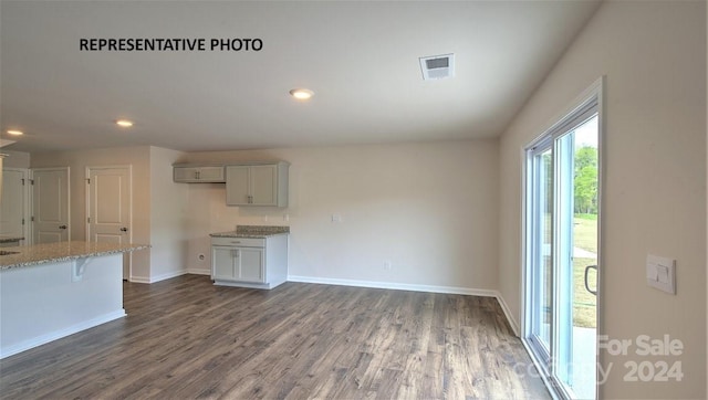 unfurnished living room with dark hardwood / wood-style floors