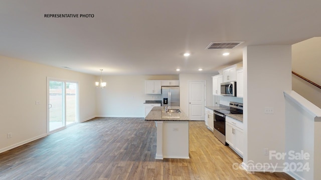 kitchen featuring white cabinetry, light wood-type flooring, a kitchen island with sink, and appliances with stainless steel finishes