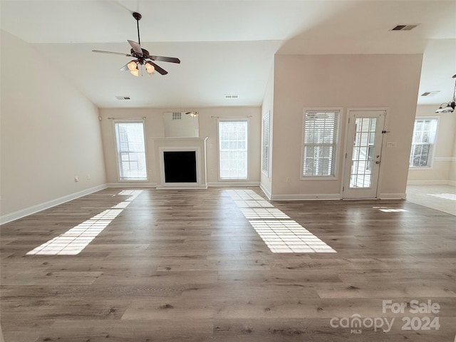 unfurnished living room with ceiling fan, dark hardwood / wood-style flooring, and high vaulted ceiling