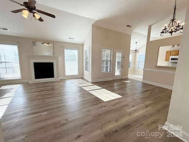 unfurnished living room with ceiling fan, dark hardwood / wood-style flooring, and high vaulted ceiling