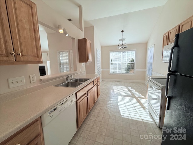 kitchen with dishwasher, lofted ceiling, black fridge, sink, and range