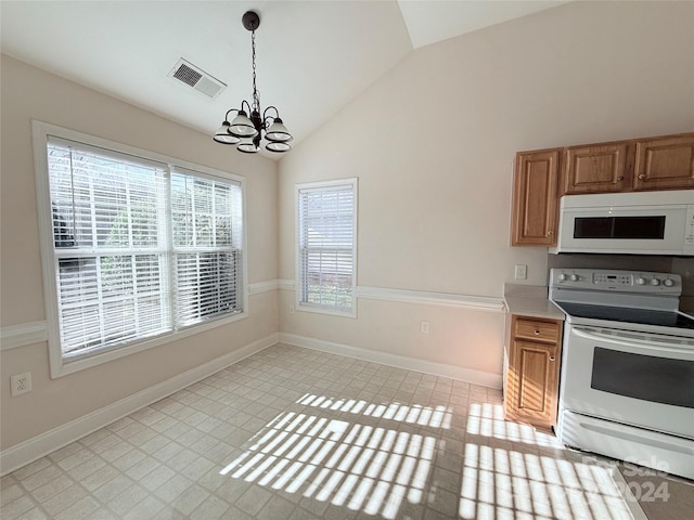 kitchen featuring lofted ceiling, white appliances, decorative light fixtures, and a notable chandelier