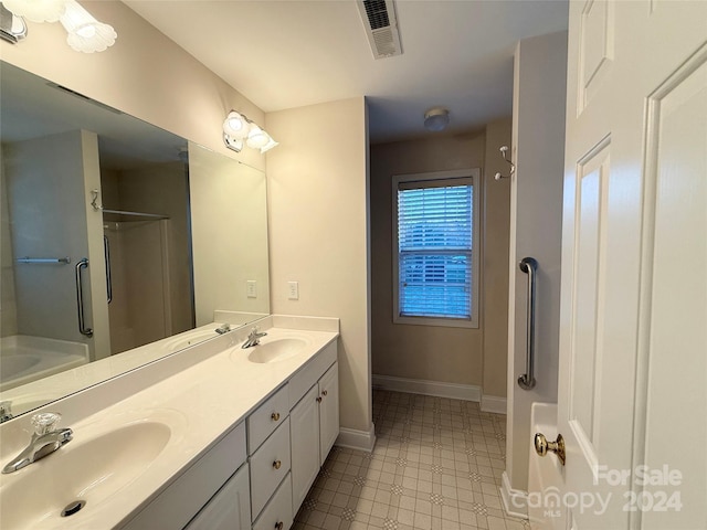 bathroom with vanity and shower with separate bathtub