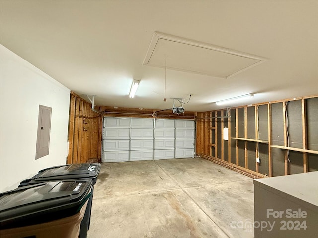 garage featuring electric panel and a garage door opener