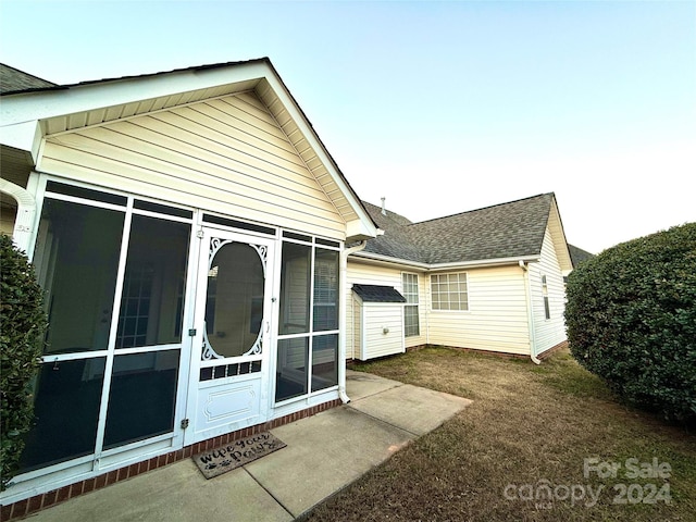 back of house with a sunroom