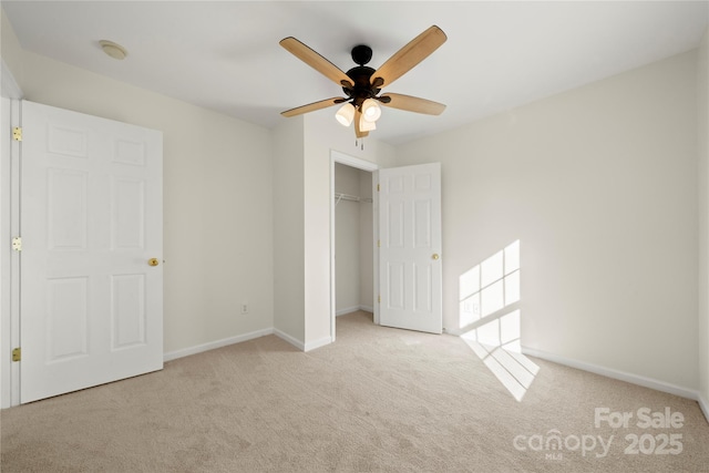 unfurnished bedroom with ceiling fan, light carpet, and a closet