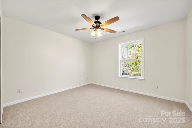 carpeted spare room with ceiling fan