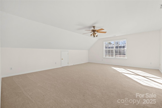 bonus room featuring ceiling fan, light colored carpet, and vaulted ceiling