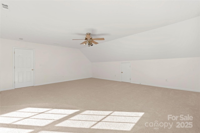 additional living space featuring ceiling fan, carpet floors, and vaulted ceiling