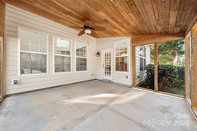 unfurnished sunroom with ceiling fan, wooden ceiling, and lofted ceiling