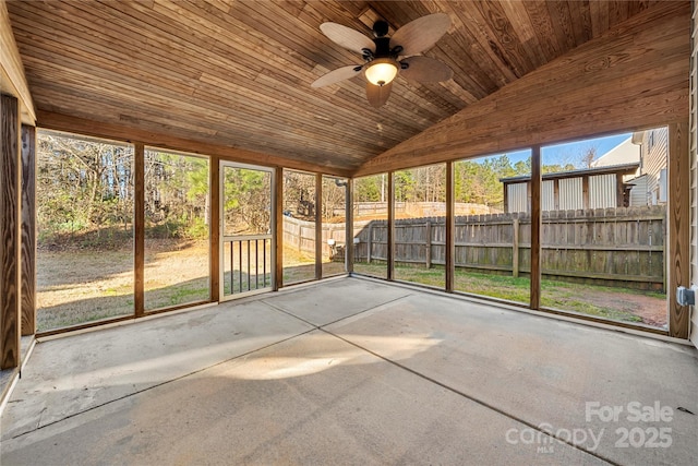 unfurnished sunroom with ceiling fan, wood ceiling, and vaulted ceiling