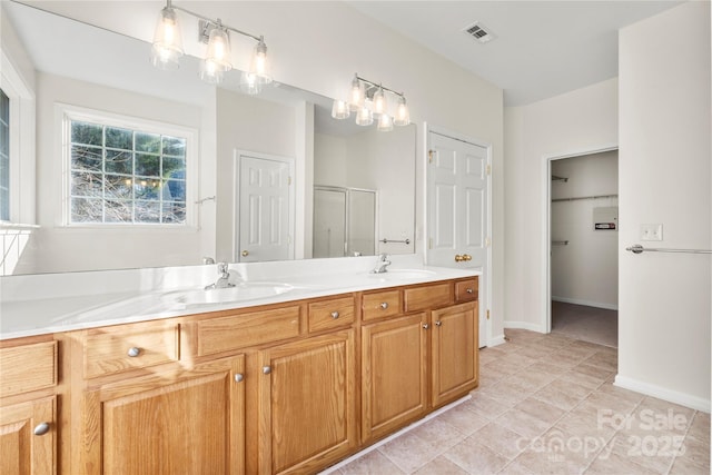 bathroom with vanity, tile patterned floors, and a shower with shower door