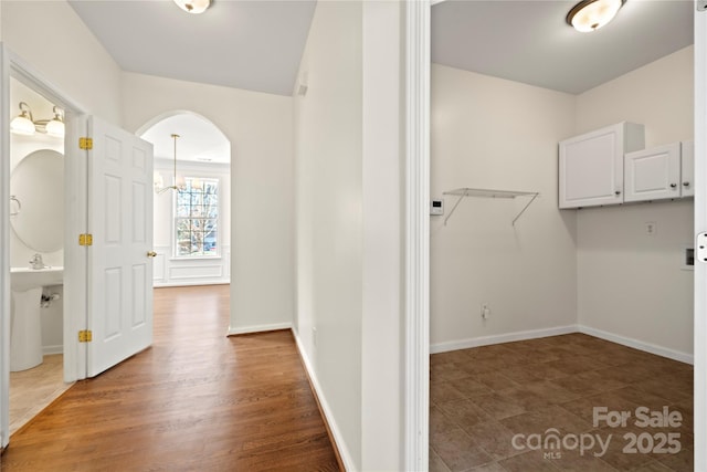 interior space featuring a chandelier and dark hardwood / wood-style flooring