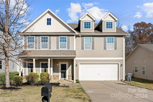 view of front of property featuring a front lawn and a garage