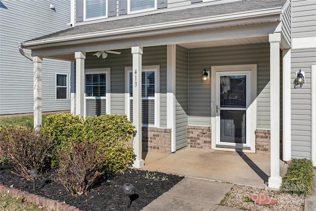 doorway to property featuring a porch and ceiling fan